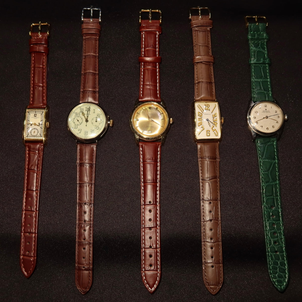 Explore vintage wristwatches: five watches with leather straps and varied case shapes.