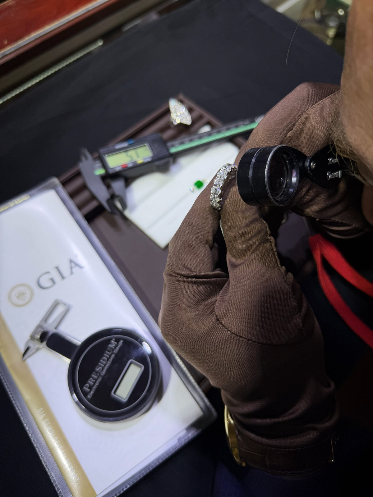 Close view of Konstantin Kupfer examining a diamond ring